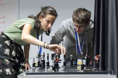 High school students working on an optical setup during BIYSC